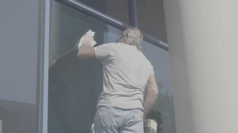 Man Cleaning Large Blue Window - RAW Stock Footage 209289918