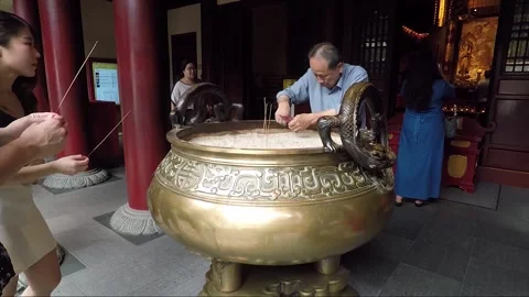 Man Cleaning Large Incense Burner inside Buddha Tooth Relic Temple, Singapore Stock Footage 328565035