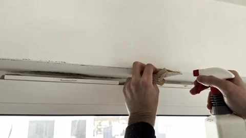 Man cleaning mold above window frame Video stock 333305491