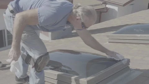 Man Cleaning Newly Installed Skylight Window (RAW) Stock Footage 212418190