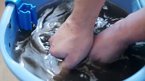 Man cleaning plastic filter box of home aquarium, dirty water in bucket because 스톡 동영상 302401592