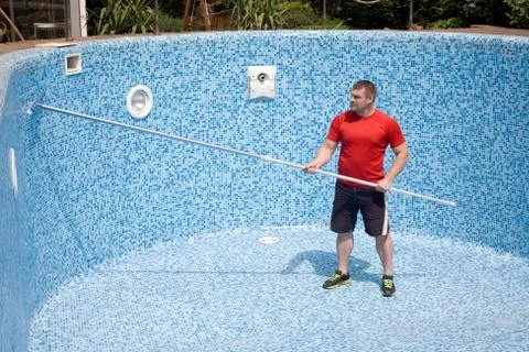 A man Cleaning the pool Stock Photos