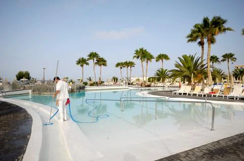 Man cleaning pool Stock Photos