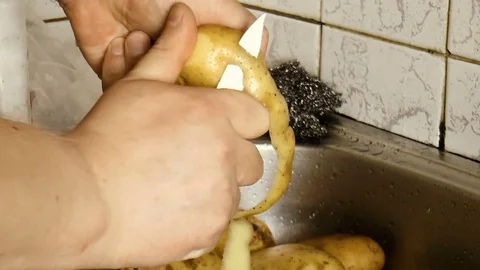 Man cleaning potatoes Stock Footage 78304278