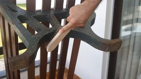 Man cleaning rust on branch with brush Stock Footage 116741549