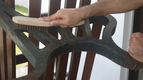 Man cleaning rust on branch with brush Video stock 116741551