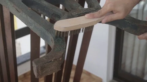 Man cleaning rust on branch with brush Video stock 116741554