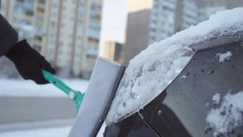 The man is cleaning the snow from the car Stock Footage 83355895