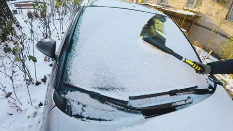 Man Cleaning Snow From Car Windshield With Brush, Slow Motion Stock Footage 327077580
