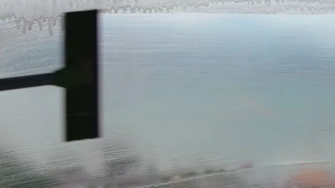 Man cleaning soap window with squeegee with view on beautiful sea landscape Stock Footage 89345209