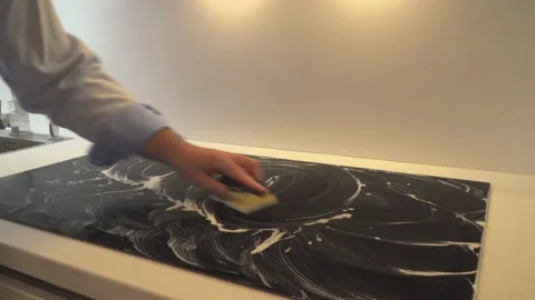 Man cleaning stove in kitchen Video stock 145422156