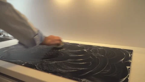 Man cleaning stove in kitchen Video stock 145422359