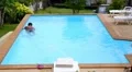 Man Cleaning Swimming Pool. HD Footage