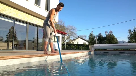  	Man cleaning swimming-pool Stock Footage 72009996