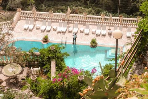 A man cleaning the swimming pool Stock Photos
