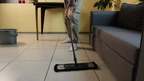 Man cleaning tiled floor with mop at home. Domestic lifestyle video of everyday Stock Footage 316060179