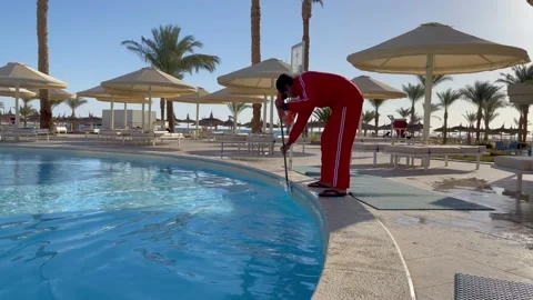 Man cleaning the walls of the pool with a brush. Hurghada, Egypt - February 2022 Stock Footage 169864650