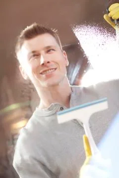 Man cleaning window pane Stock Photos