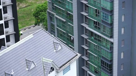 Man cleaning windows in a high rise building in Novena. Stock Footage 137317932