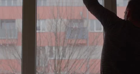 Man Cleaning Windows with a Squeegee in Bright Interior Stock Footage 316491241