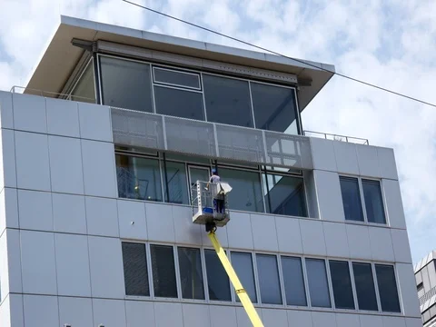 A man is cleaning windows on telescopic stage Stock Footage 78783995