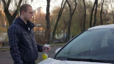 Man cleaning windscreen of a car. Stock Footage 70359155