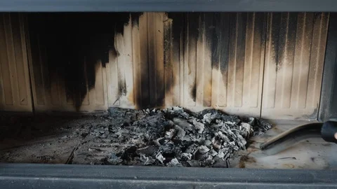 A man cleans the ashes in the fireplace with a vacuum cleaner, close-up Stock Footage 101389751