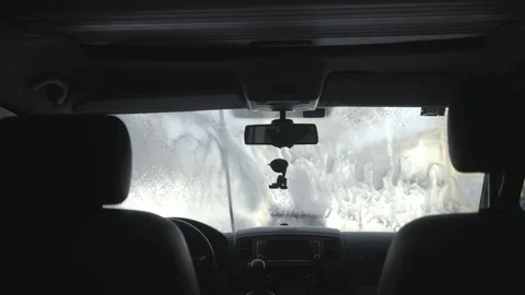 Man cleans big van or car at self service car wash Stock Footage 79828128