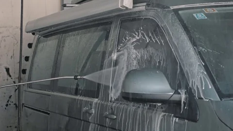 Man cleans big van or car at self service car wash Stock-Footage 79828812