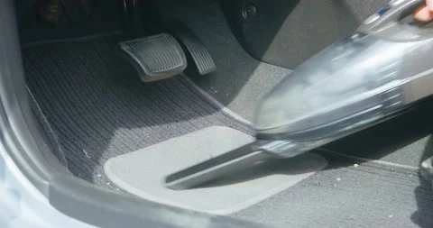 Man cleans black textile mats in car removing dog wool Stock Footage 166979063