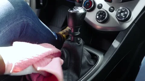 The man cleans the car from the dust using a damp cloth. Cleaning a dashboard Stock Footage 130861495