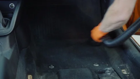 Man cleans car interior with vacuum cleaner Stock Footage 93481324