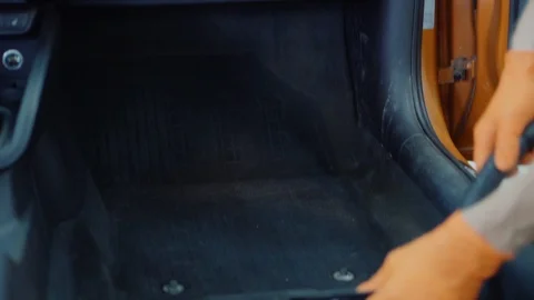 Man cleans car interior with vacuum cleaner Stock Footage 93481704