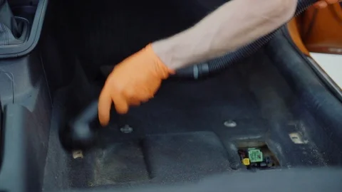 Man cleans car interior with vacuum cleaner Stock Footage 93481905