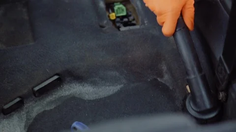 Man cleans car interior with vacuum cleaner Stock Footage 93482273