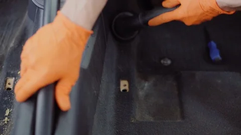 Man cleans car interior with vacuum cleaner Stock Footage 93482468
