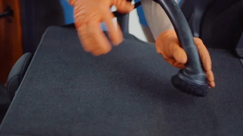 Man cleans car interior with vacuum cleaner Stock Footage 93482797