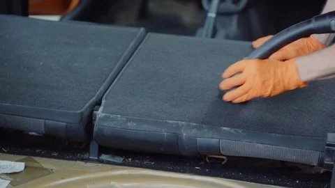 Man cleans car interior with vacuum cleaner Stock Footage 93483109