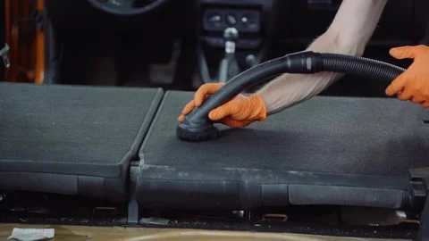 Man cleans car interior with vacuum cleaner Stock Footage 93483341