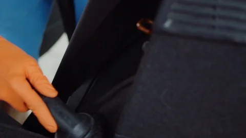 Man cleans car interior with vacuum cleaner Stock Footage 93483537