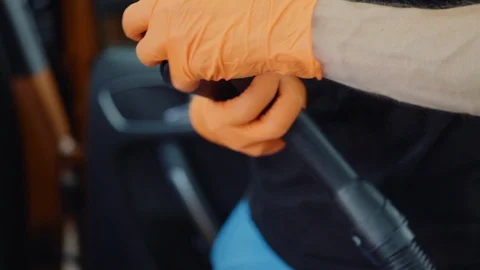Man cleans car interior with vacuum cleaner Stock Footage 93484411