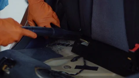 Man cleans car interior with vacuum cleaner Stock Footage 93484773