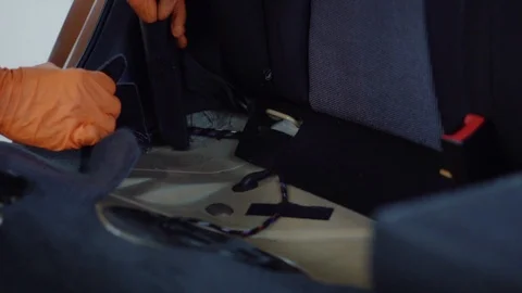 Man cleans car interior with vacuum cleaner Stock Footage 93485129