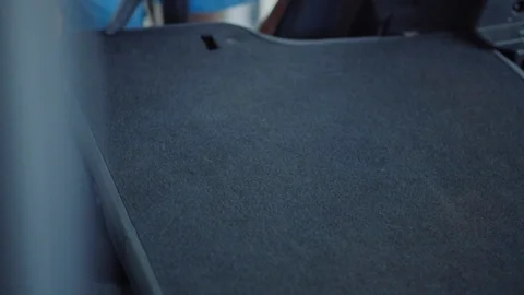 Man cleans car interior with vacuum cleaner Stock Footage 93485344