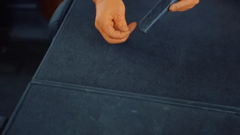 Man cleans car interior with vacuum cleaner Stock Footage 93485634