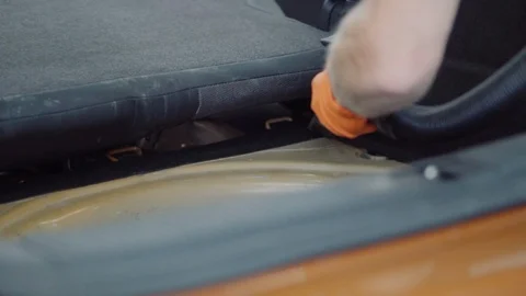 Man cleans car interior with vacuum cleaner Stock Footage 93485846