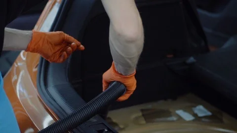 Man cleans car interior with vacuum cleaner Stock Footage 93486158