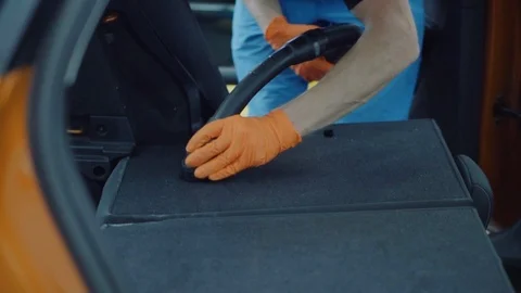 Man cleans car interior with vacuum cleaner Stock Footage 93486912