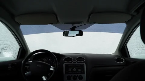 Man cleans the car from the snow, the view from inside the car Stock Footage 88921651