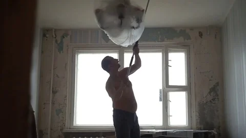 A man cleans the ceiling Stock Footage 83304889